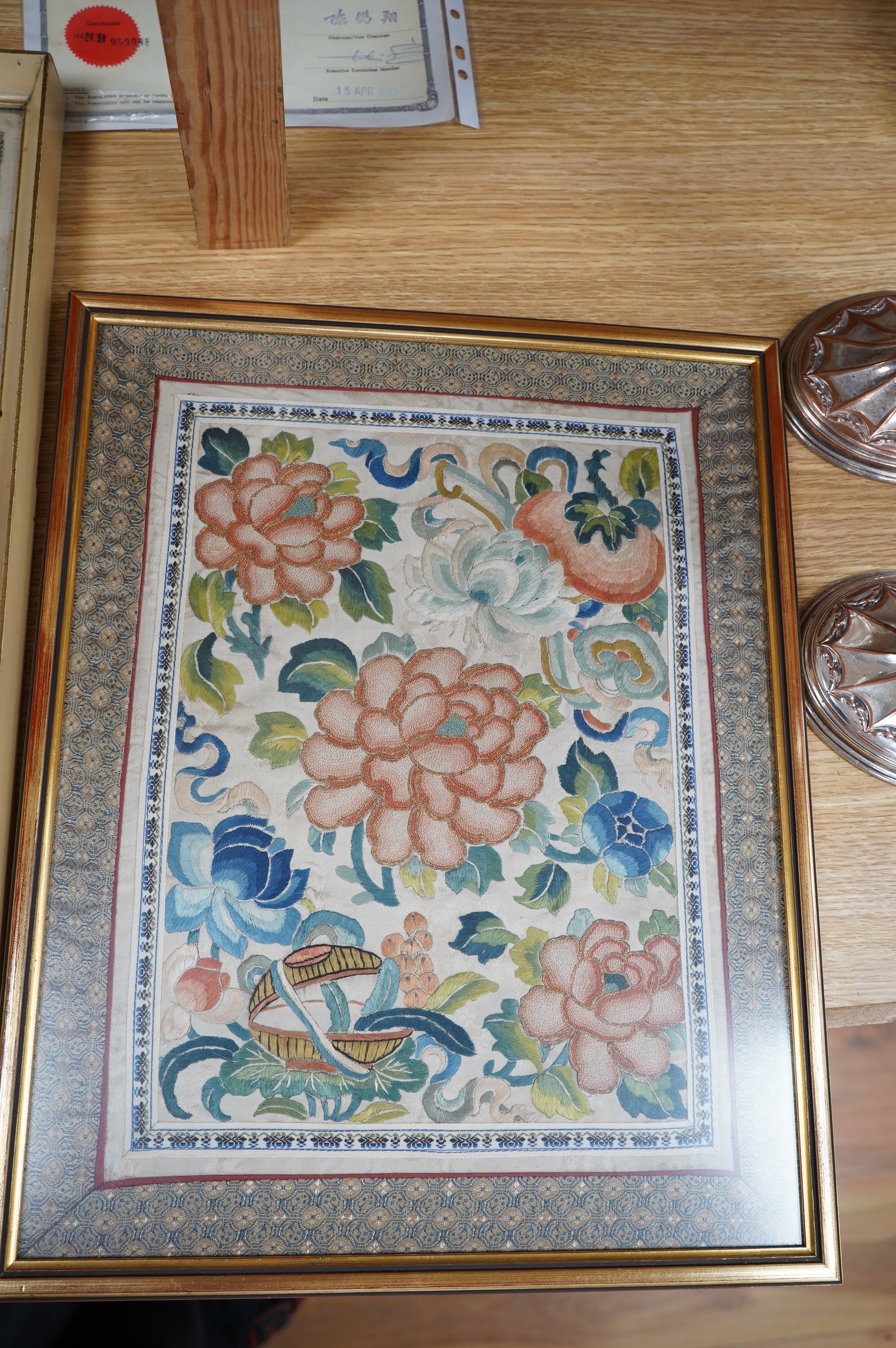 A framed pair of late 19th century embroidered sleeve bands now as a tray and a framed Chinese knot floral silk embroidery, Chinese knot embroidery 30.5cm wide x 39cm high., Condition - the sleeve bands are stained the f